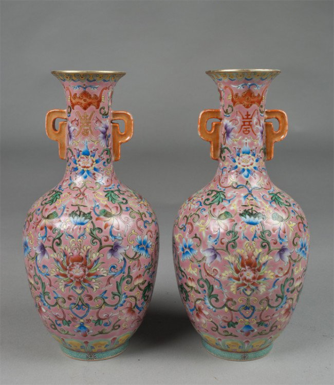 Pr. Of Chinese Famille Rose Porcelain Vases: Finely enameled with lotus blossoms and tendrils, the neck with shoe symbols and bats, all against a pink ground with ruyi handles, the interior and foot rim in turquoise, both with seal mark in under