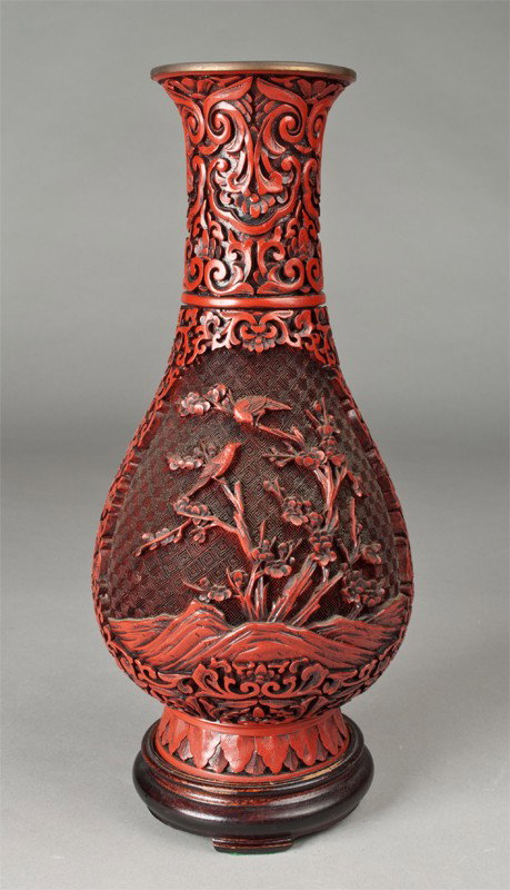 Chinese Cinnabar Vase on Stand: Finely carved to depict birds within a landscape on both sides, with fitted wood stand. 12" H, not including stand. Circa 20th century.