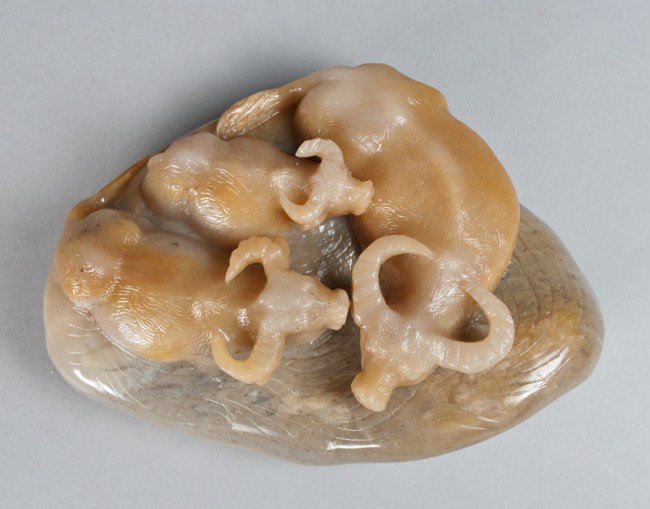 A Fine Chinese Carved Soapstone Boulder: Finley carved to depict watering buffalo, the stone a celadon tone with russet inclusions, very well done with a fine polish, 5.5"W x 4"D, circa late 19th century.