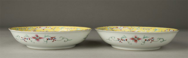 Pr. Of Chinese Famille Rose Bowls: Each footed bowl in yellow ground with five symbols in gilt amid pink peaches and blue bats with gilt rim. Six character mark in iron red on underside. 3 & 1/8" H x 5 & 3/8" Dia., 20th century.