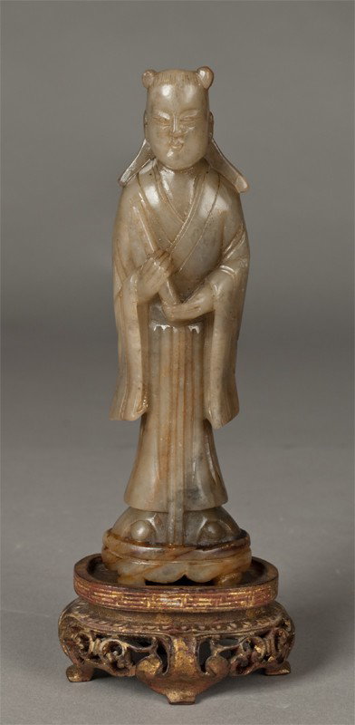A Fine Chinese Soapstone Carving Of An Elder: Finley carved to depict a standing elder holding a scroll, fully robbed, together with a carved giltwood stand, 6"H, not including the stand, circa 19th century.
