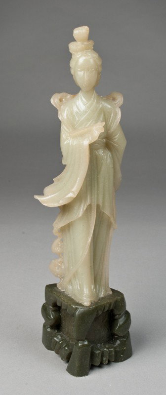 Chinese Soapstone Carving Depicting Guanyin: Finley carved to depict Guanyin standing holding a tablet, standing in a rocky outcrop base in deep green, 9.25"H, circa 20th century.