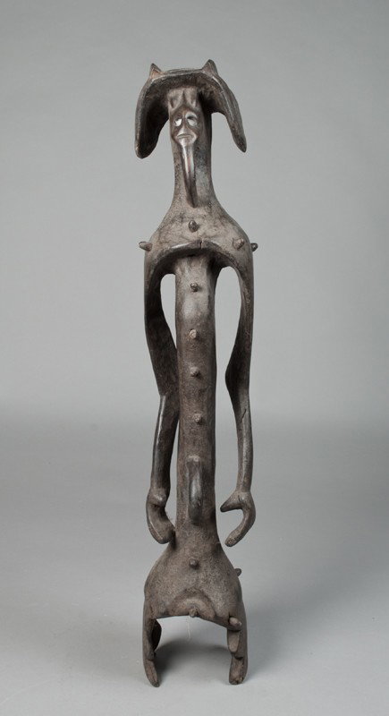 African Mumuye Tribe Carved Figure: Finely carved male figure with hat, looped chin, looped naval, and wood pegs visible. In the Mumuye tribe, the rhythms and disciplines of daily life have been governed by traditional ceremonies in whi