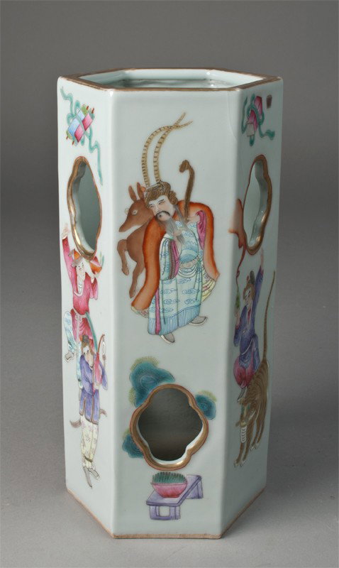 A Fine Chinese Famille Rose Hat Stand: Finely enameled to depict figures, animals and antiques with cut-outs highlighted in gilt as well as rim. Six character mark in iron red on underside. 11.25" H, surface crack on two areas at top, exte