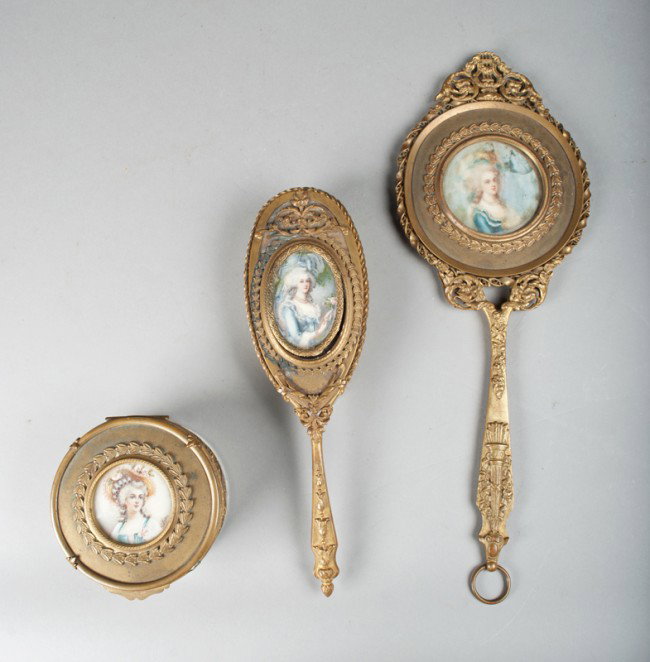 (3) Piece Painted Ivory Gilded Bronze Vanity Set: Consisting of a mirror, brush and covered powder box, each with a hand painted ivory French portrait of various ladies. The powder box is signed Dupre, possibly Louis Dupre (1789-1857), known for his 