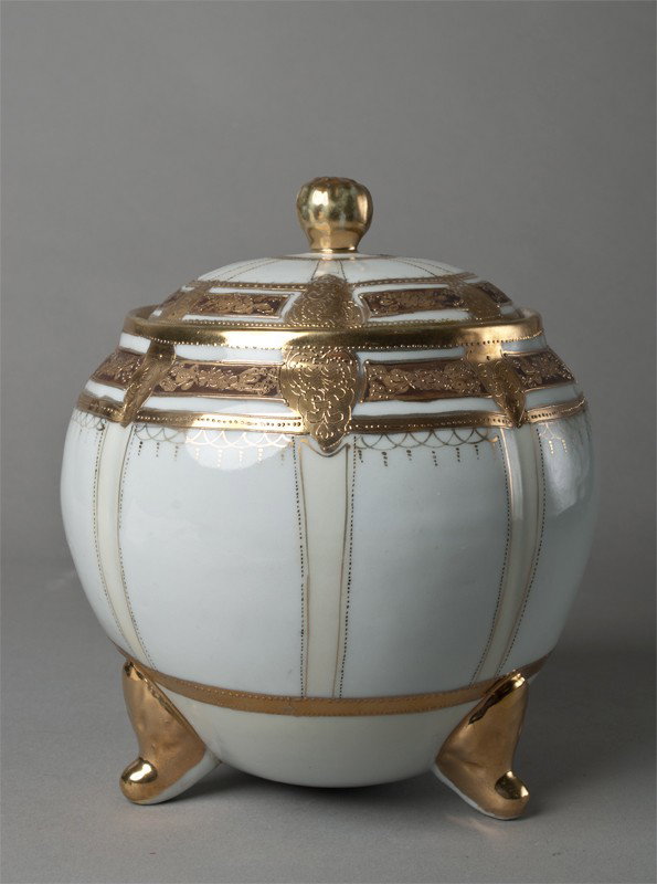 Nippon Covered Jar: Heavily gilded with art deco designs, signed with green mark, resting on three feet, 7"H, circa 1920, slight wear to gilt, very nice piece.