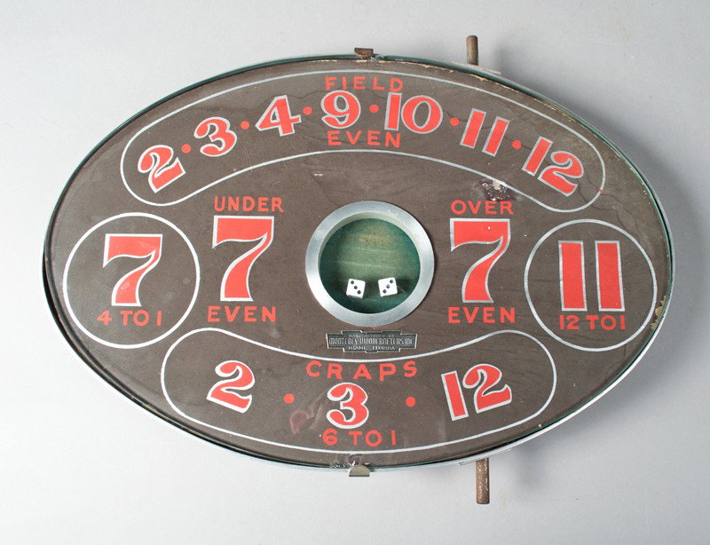 1950's Monterey Woodcrafters Gaming Board: Oval game board with glass top to house dice which is activated by a lever, to play various games. Tag in front "Manufactured by Monterey Woodcrafters Inc. Miami, Florida." 18" L x 12" W, circa 1950's