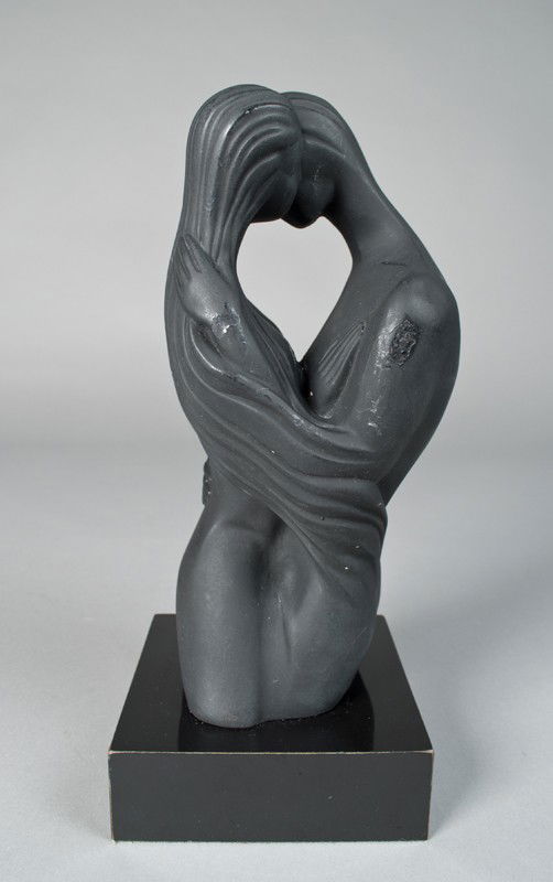 Mid. Century Modern Porcelain Sculpture: Depicting a male and female in an embrace, attached to stand. Signed Boris, 10.75" H, some paint loss and touch up on male shoulder and hand.