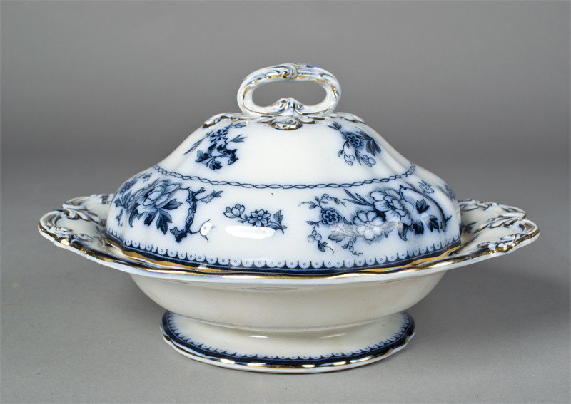 A Fine Flow Blue Burleigh Ware Covered Dish: Covered dish depicting floral designs and highlighted rims and handles in gilt. Mark on underside Burleigh Ware Stratford Burslem England Geo f Bassett & Co. Inc. Copyrighted, as well as impressed B o