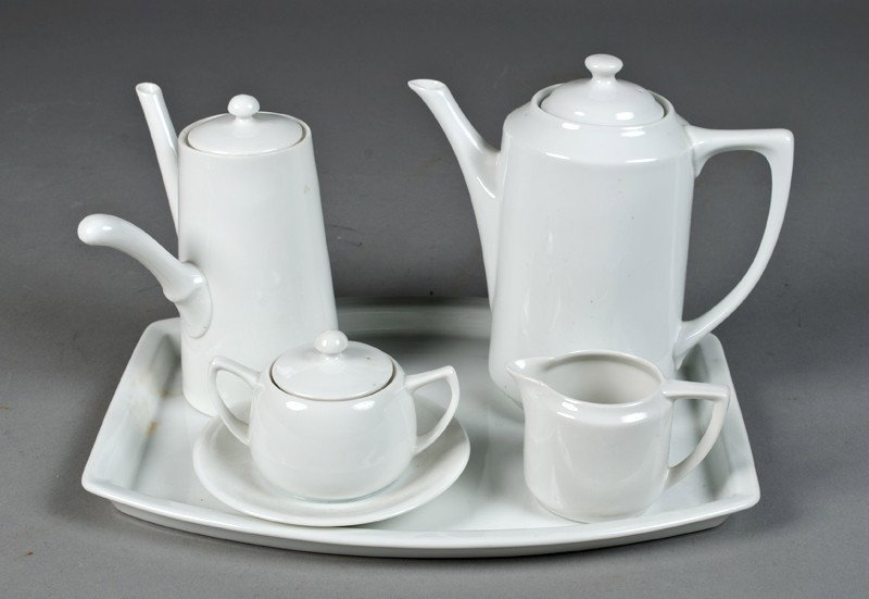 (5) Piece Nippon White Porcelain Tea Set: Includes a coffee pot, a side handled tea pot, a creamer, a sugar bowl with attached underplate, and a matching tray. Stamped "Nippon" in green on bottom. Longest piece measures 11", and in very good 