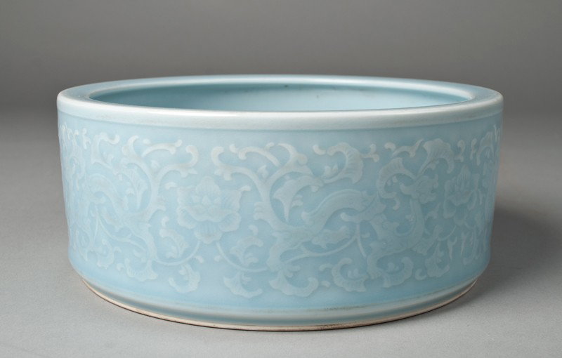 Chinese Porcelain Brush Washer: Finely molded to depict dragons, scrolling and floral designs in a sky blue glaze. Six character mark in underglaze blue for Great Qing Qianlong Production on underside. 3.25" H x 8 & 1/8" Dia., circa