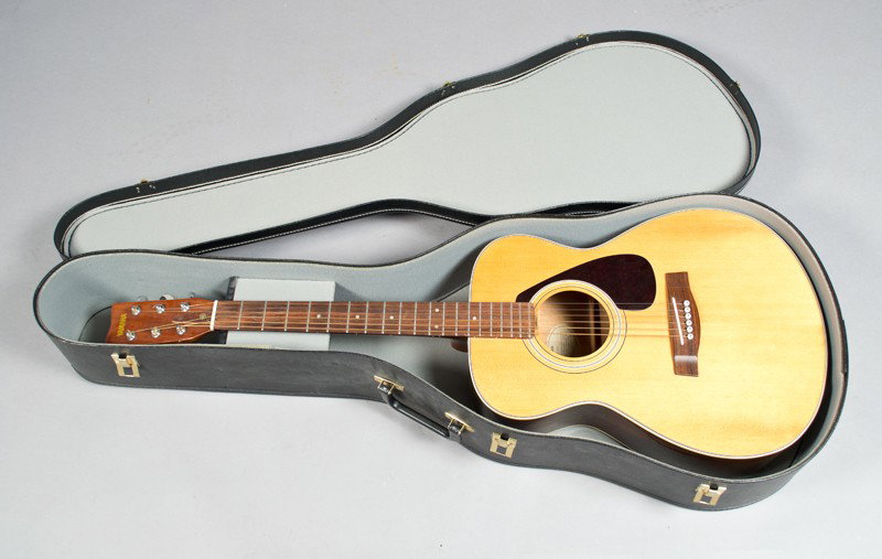 A Fine Yamaha Six String Acoustic Guitar: Model FG331, with hard-shell case. 40" L, and in good working condition.