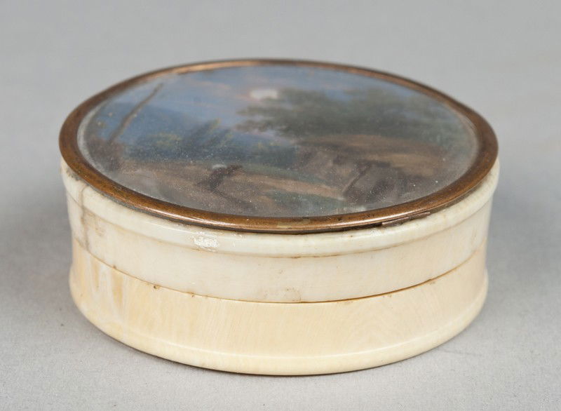 A Finely Painted Ivory Trinket Box: Circular box with painted lid to depict a figure walking in the forest at night. 5/8" H x 2" Dia., good condition with some loss to painting at bottom. 20th century.