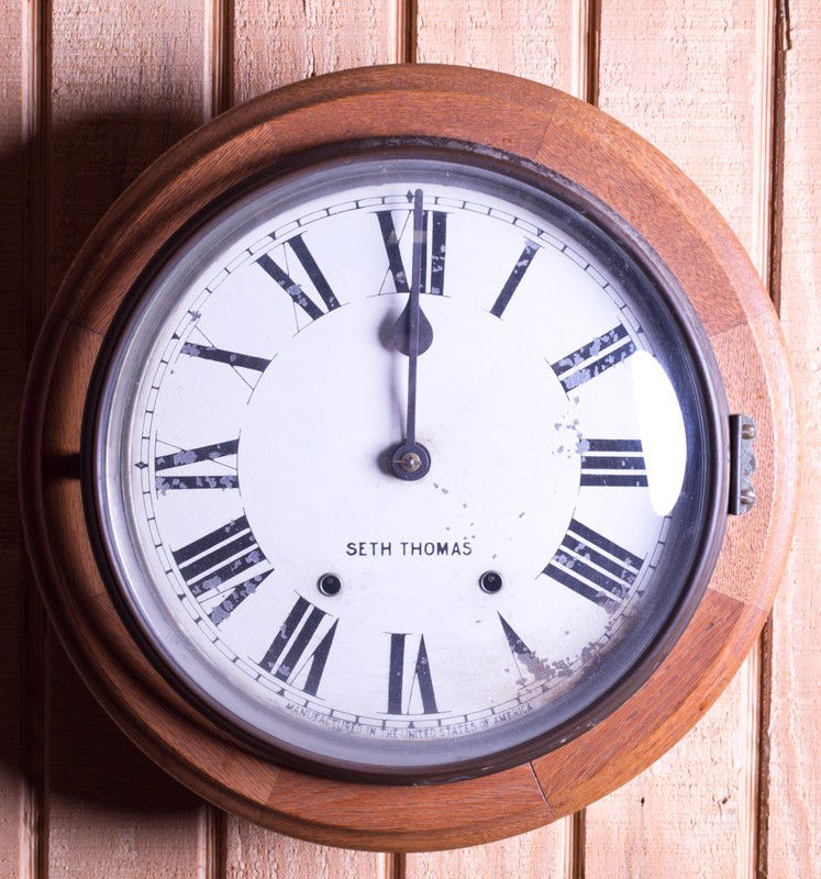 A Fine Seth Thomas Round Wall Clock: Oak case, dial marked Seth Thomas and Manufactured in the United States of America. 15.5" Dia., with original key and in working condition. Wear to dial.