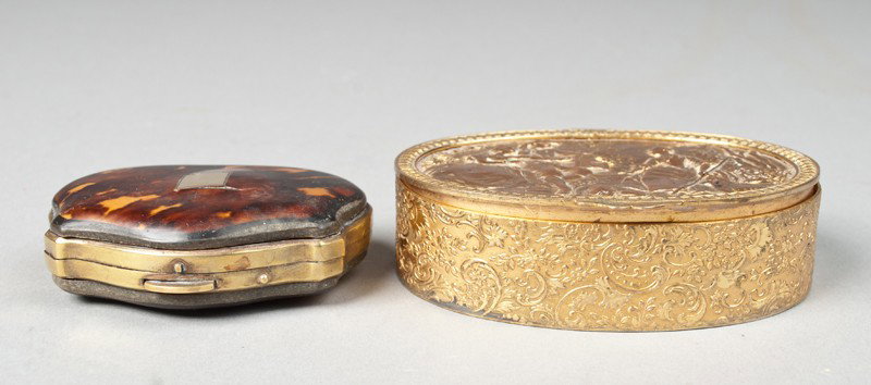 (2) English Tortoise Shell & Brass Snuff Boxes: One tortoise shell and brass box of cartouche shape with fitted brass plaque, interior lined with old green velour. 2.75" L. Together with a oval gilt brass or copper snuff box depicting figures in a 