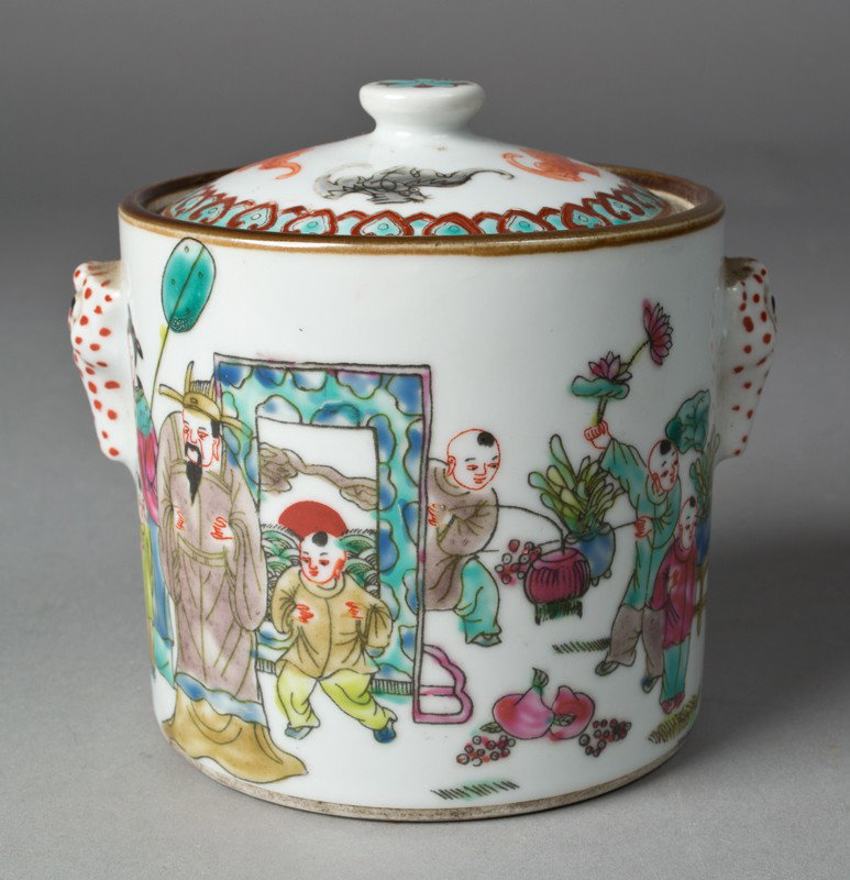 A Fine Chinese Famille Rose Covered Jar: Finely enameled depicting figures in an interior/exterior scene with flying iron red bats, two beast handles and iron red and black painted bats on lid. Four character mark within two squares in iron 