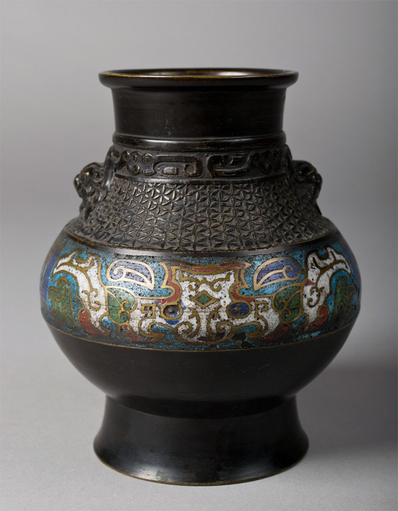 Japanese Bronze and Champleve Enameled Vase: Finely molded with two foo dog handles, finely enameled to depict the face of the beast, 6" H circa early 20th century.