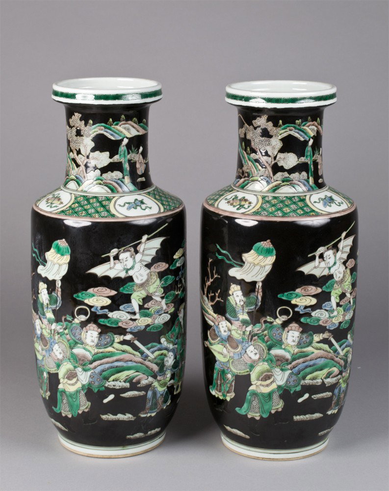 Pr. Of Chinese Famille Noire Bang Chui Vases: Black ground, finely decorated with warriors and a winged figure in a landscape, with bats and ruyi. Two concentric circles in underglaze blue on underside. 16" H x 6.5" W, circa 20th century.