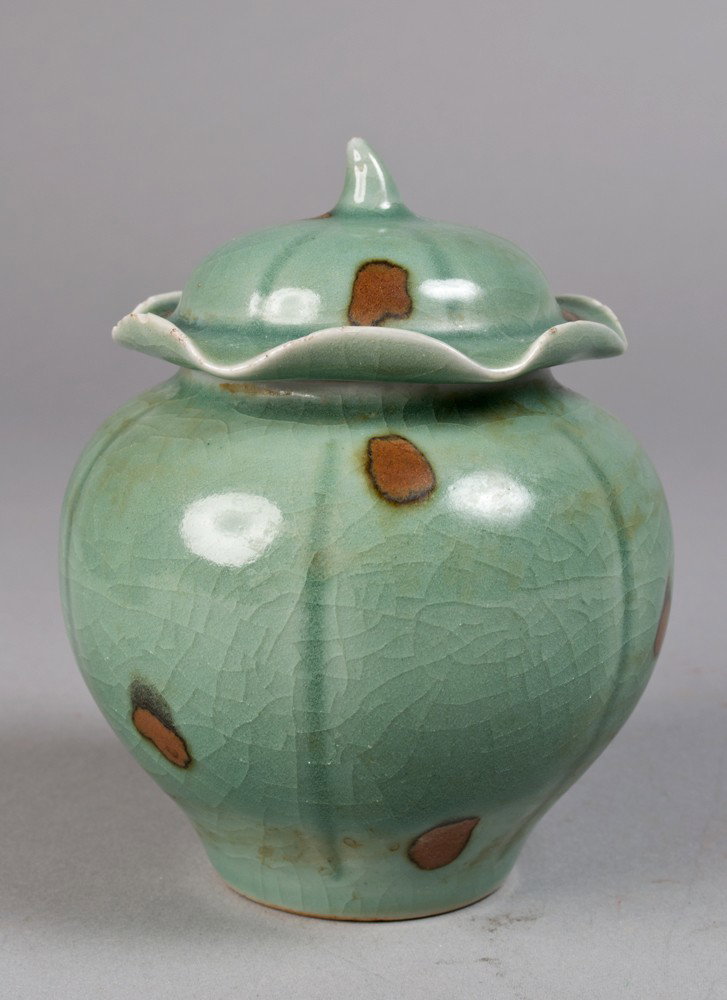 Fine Chinese Celadon and Iron Red Lotus Jar: A small jar of lotus shape finely glazed in celadon with iron red splashes throughout, 4.75"H, circa 18th century.