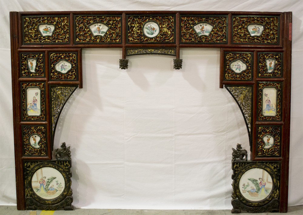 Chinese Giltwood Bedframe & Porcelain Plaques: A finely carved giltwood and painted bedframe with carved dragons with riders inset with fifteen hand painted porcelain plaques in various forms all finely painted in the Famille rose palette some pla