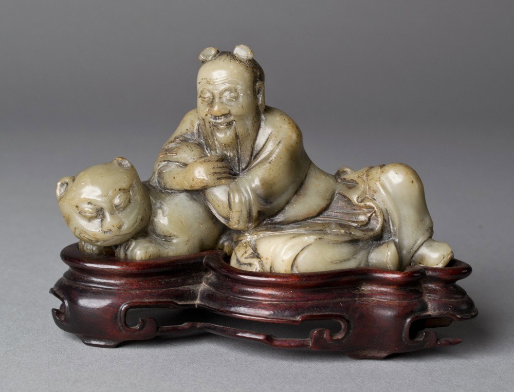 Chinese Carved Soapstone Figure: Depicting Fuhu Lohan with fitted wood stand 4.5"L X 2.5"H.