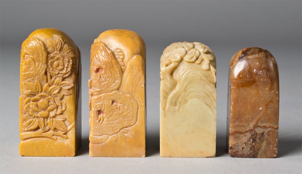 (4) Carved Soapstone Seal Chops: All finely carved in the form of mountains three additional caved with lotus blossoms and tendrils each seal carved with a different seal mark tallest is 2.5"H, circa late 19th/early 20th century.
