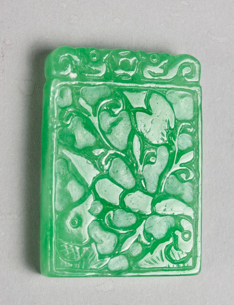 A Fine Chinese Carved Jadeite Pendant: Finely carved on both sides to depict bats and lotus the stone an apple green tone with fine polish 1.625"H X 1.125"W circa late 19th-early 20th century.