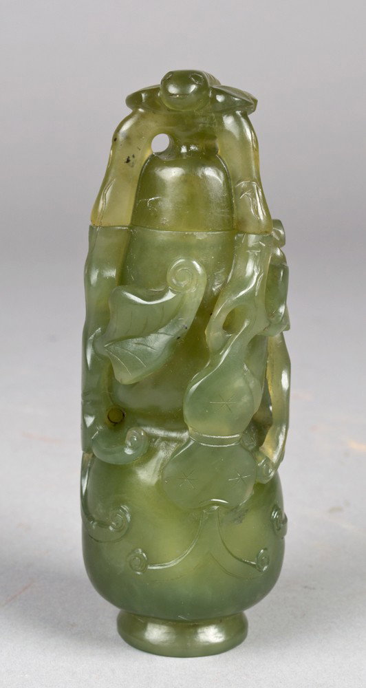 Chinese Carved Serpentine Jade Vase & Cover: Of double gourd form, finely carved to depict lotus and double gourds, the finial depicting a carved insect, on a fitted carved hardwood stand. 5.5" H, not including the stand. Circa late 19th/early 2