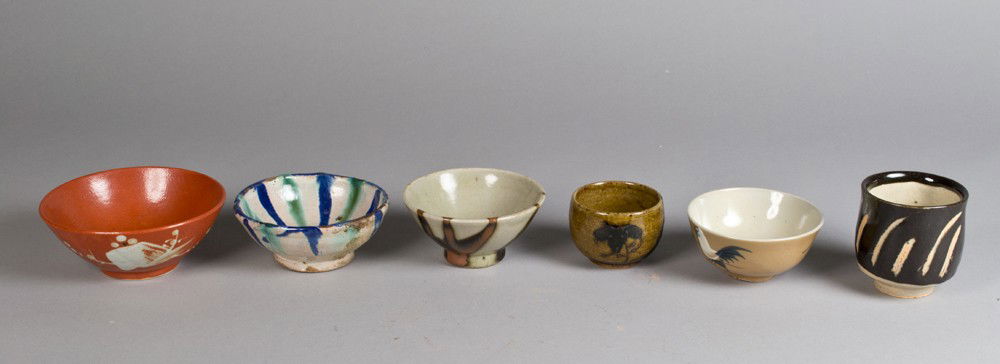 (6) Pcs. Japanese Teawares: To include four tea bowls in various decorations, one with rim chip and one with stress cracks, together with two tea cups, all unsigned largest is 3.375"H, circa early 20th century.