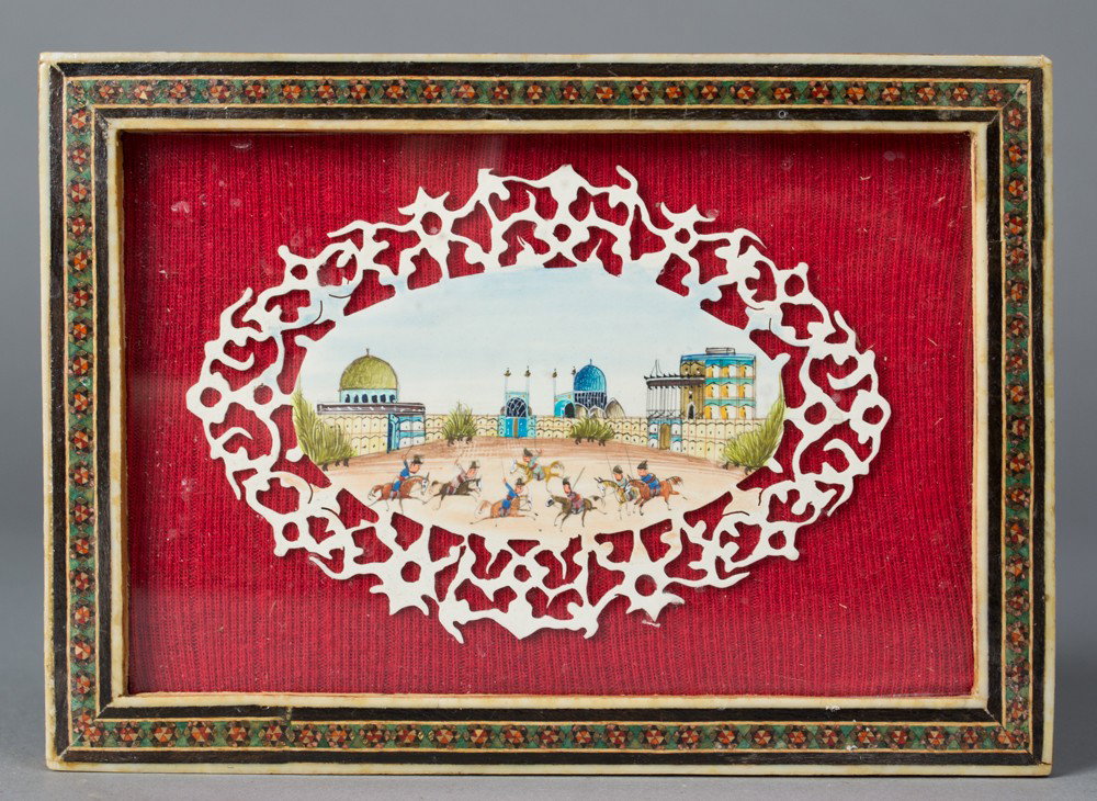 An Indian Mughal Painting on Bone: Finely painted to depict polo players in front of the Taj Mahal the plaque with open work carvings framed and mounted in inlaid wood and bone frame, the plaque 4.5"W X 3.25"H not including the frame c