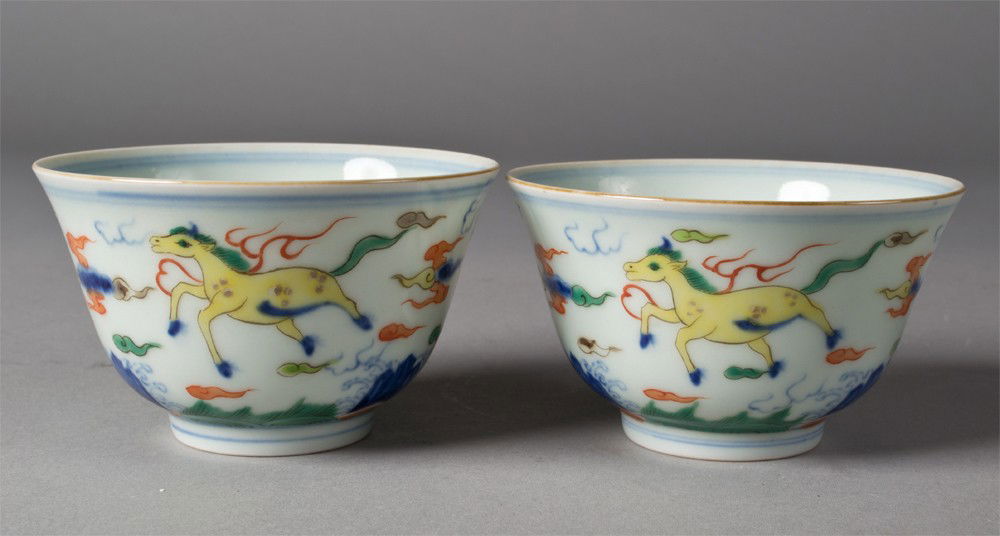 Pr. Chinese Famille Verte Tea Cups: Both finely painted to depict crystals on the interior, the exterior decorated with mythical beasts amid ruyi both with six character mark within two circles in underglaze blue, 2.1/8"H circa 19th cen