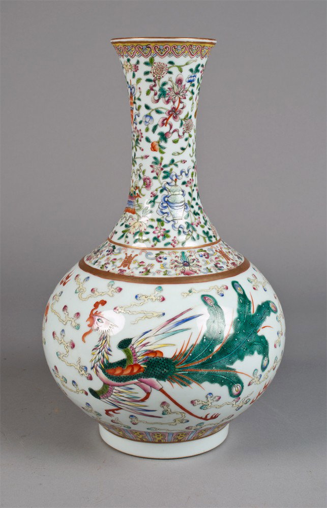 Chinese Famille Rose Porcelain Vase: Finely enameled to depict dragons and phoenix amongst ruyi clouds the nick and shoulder decorated with precious object lotus blossoms and tendrils the recessed base with six character mark in iron red