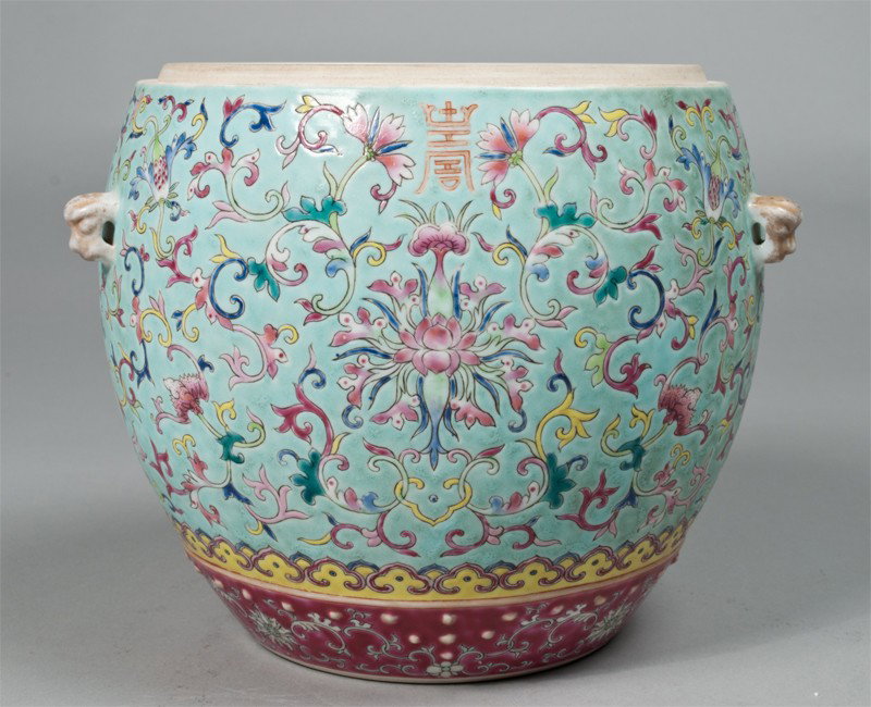 A Fine Chinese Guangxu Drumstool Porcelain Jar: A fine Famille rose drumstoll jar finely painted to depict bats amongst lotus blossoms and tendrils, with dragon head handles in gilt, the base with Guangxu six character mark in iron red. Provenance 
