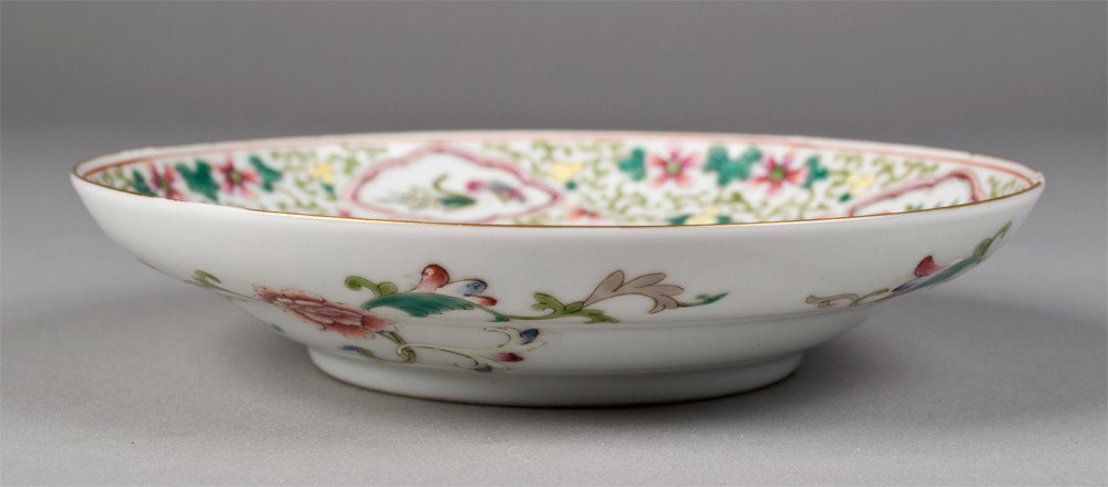 Chinese Famille Rose Porcelain Bowl: Finely enameled to depict a central dragon in iron red with a flaming pearl, with surrounding butterflies and floral designs, and gilt highlights throughout. Six character mark in iron red on undersid