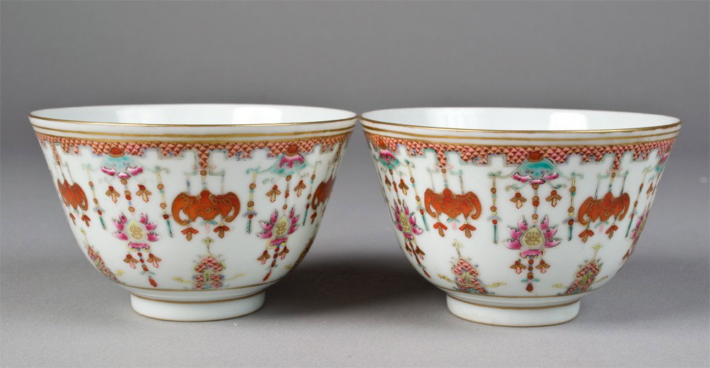 Pr. Of Chinese Famille Rose Porcelain Bowls: Finely enameled to depict hanging bats and beads with symbols with gilt highlights. Six character mark in iron red on underside. 2 & 5/8" H x 4.25" Dia., circa 20th century.