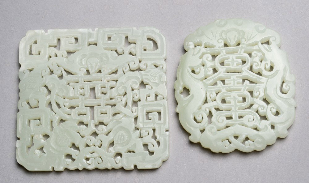 (2) Chinese Carved Jade Plaques: One square form with openwork carvings of a symbol and bats, the other with openwork carving of a symbol and bats. Largest 2 & 3/8" Sq. Circa 20th century.