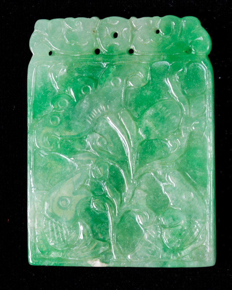 Chinese Carved Jadeite Plaque: Finely carved on one side to depict archaic symbols and bats there reverse with lotus blossoms and fish the stone with apple green and white inclusions and polish 1.75"L X 1.375"W circa 20th century.