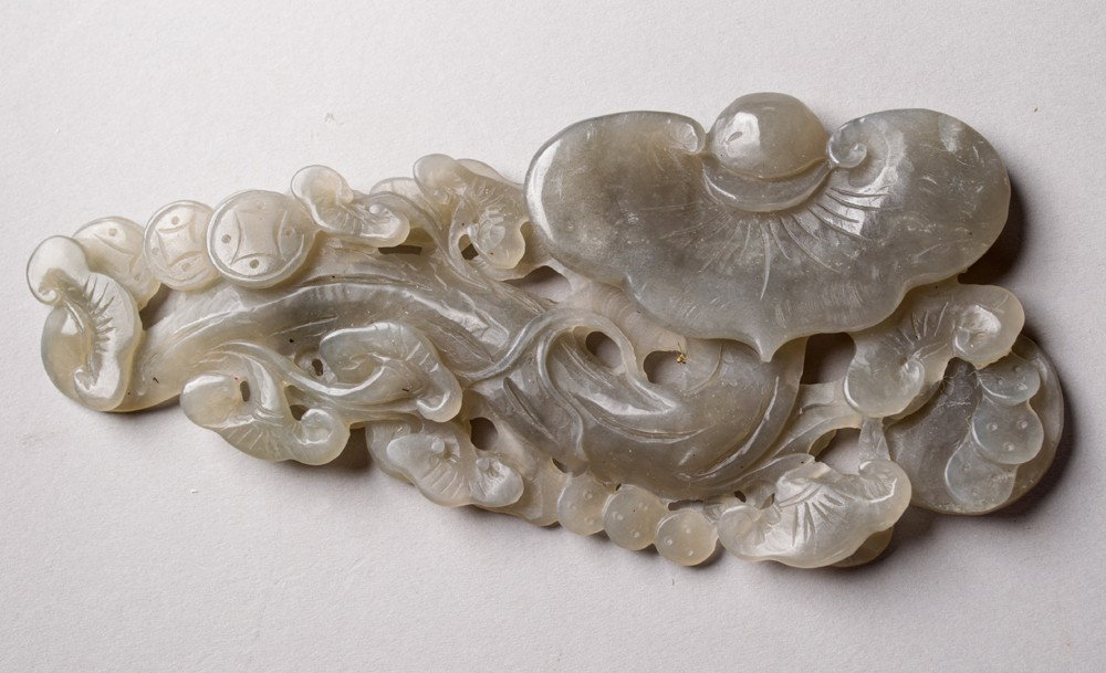 Chinese Carved Jade Ruyi Scepter: Finely carved on both sides to depict a ruyi scepter with Chinese coins. 6" L, circa 20th century.