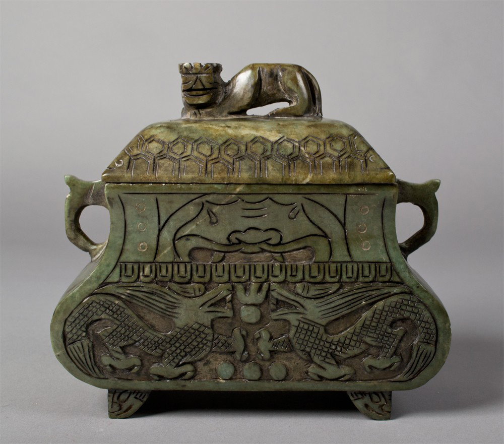 Chinese Carved Hardstone Covered Censor: Finely carved to depict the face of the beast above dragons chasing a flaming pearl with carved ring handles and foo dog finial, 7.25" H x 7.75" W circa 20th century