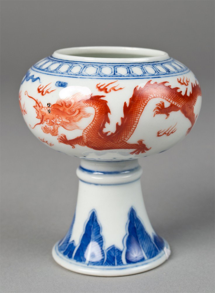 Chinese Blue & Red Porcelain Brush Washer: Footed brush washer depicting two iron red dragons chasing a flaming pearl, with blue stiff petals. Six character mark in underglaze blue on underside. 3.75" H x 3.25" W, circa 20th century.