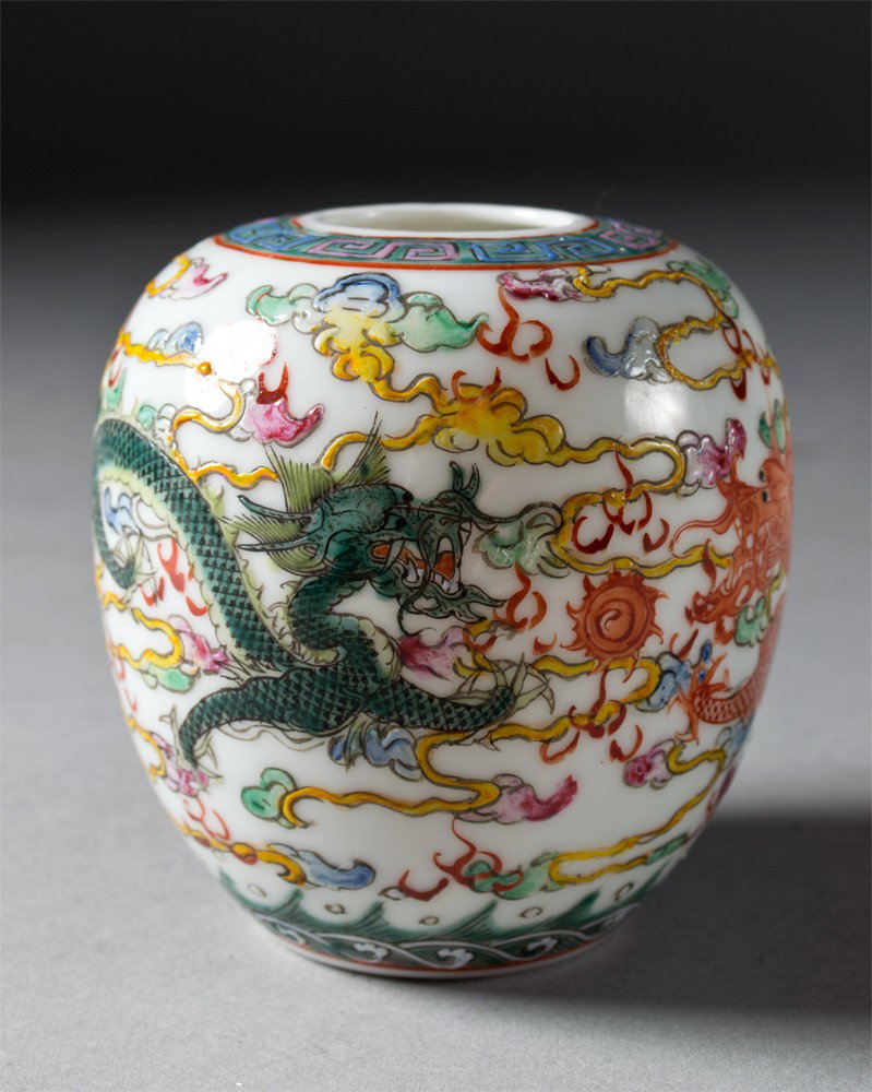 Chinese Famille Rose Porcelain Dragon Vase: Finely enameled to depict two dragons chasing a flaming pearls against ruyi clouds the base with six character mark in iron red, very beautiful enamel work the porcelain egg shell thin, 3"H circa repu
