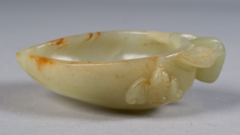 Chinese Carved Celadon Brush Wash: Finely carved to depict a peach with bats and leaves, 4"L circa early 20th century.