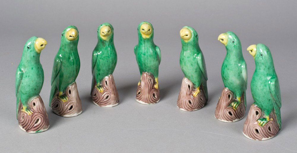 (7) Chinese Glazed Porcelain Parrots: All finely molded standing on stump form bases and glazed in green and yellow. All unmarked. All measure 4" H. Late 19th early 20th century.
