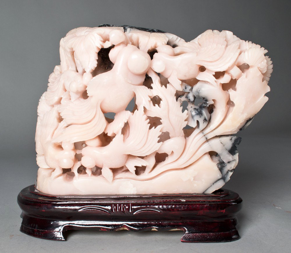 A Large and Fine Chinese Soapstone Carving: Finely caved to depict coy fish the stone pink with black inclusions finely carved on fitted hard wood stand 7"H X 9.5"W not including the stand circa early 20th century.