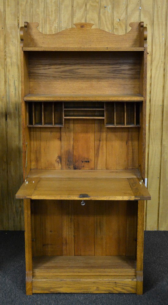 Oak Spoon Carved Secretaries Desk: Drop front with outer scalloped designs with two shelves above and two below, eight inside mail slots with scalloped top. Comes with key for locking. Measures 63" H x 11.25" W x 10" D.