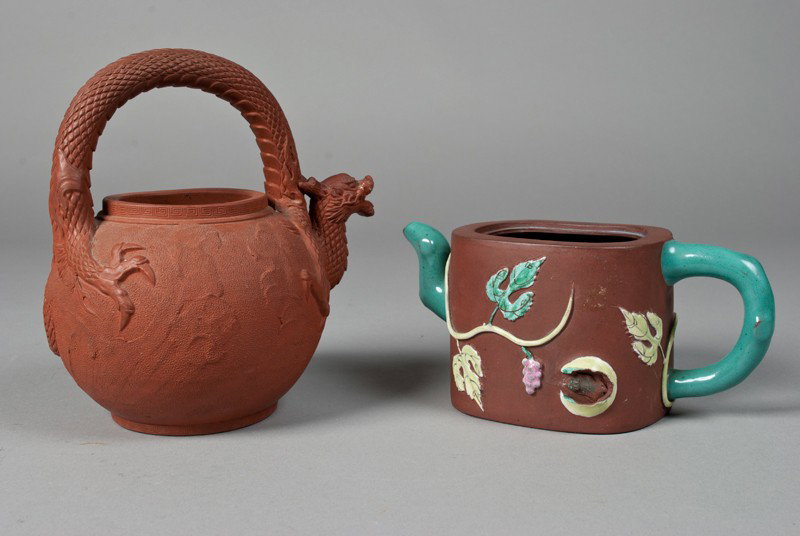 (2) Asian Clay Tea Pots, Yixing & Tokoname: Includes a Chinese yixing clay tea pot finely molded to depict branch handles and spout, the body with leafy foliage. Together with a Japanese Tokoname tea pot finely molded to depict dragon handle an