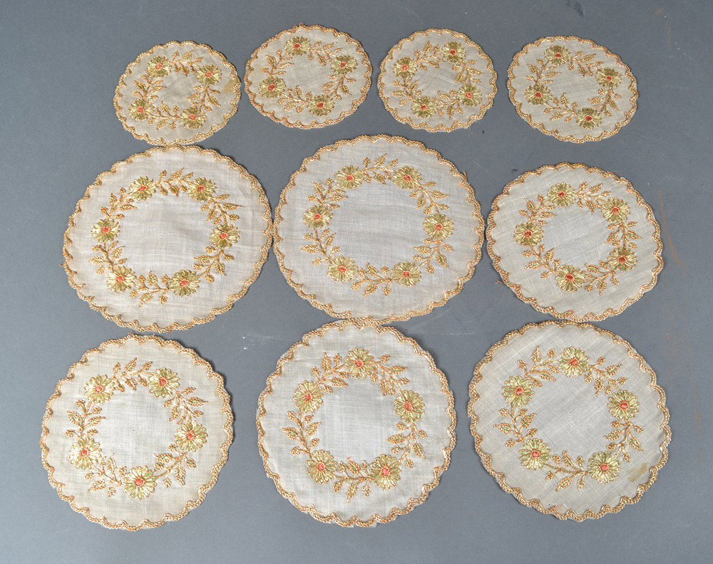 (10) Antique Silk Embroidered Doilies: Of various sizes all depicting floral decorations. Circa 1900.