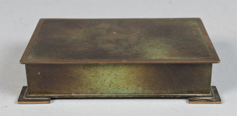 A Fine Danish Aeget Bronce Ildfast Argentor Box: Bronze box with inlaid deer on top of lid, and painted in greens and gold's. Marked Aegte Bronce Ildfast Argentor 131 on underside. 1.5" H x 6" W x 4" D.