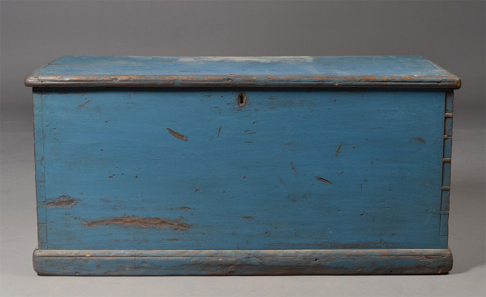 An American Pine Painted Blanket Chest: With fine cut dovetails with molded base and lid, the lid opens to reveal a lidded section till, retains original blue paint, original hinges, once moved. 18" H x 37.5" W x 17" D. Circa 19th century. 