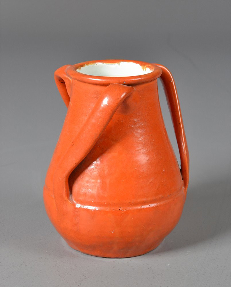 Stangl Pottery jug: With three shaped handles and burnt orage glaze, 7"H, circa early 20th century. Private collection Gregory, MI.